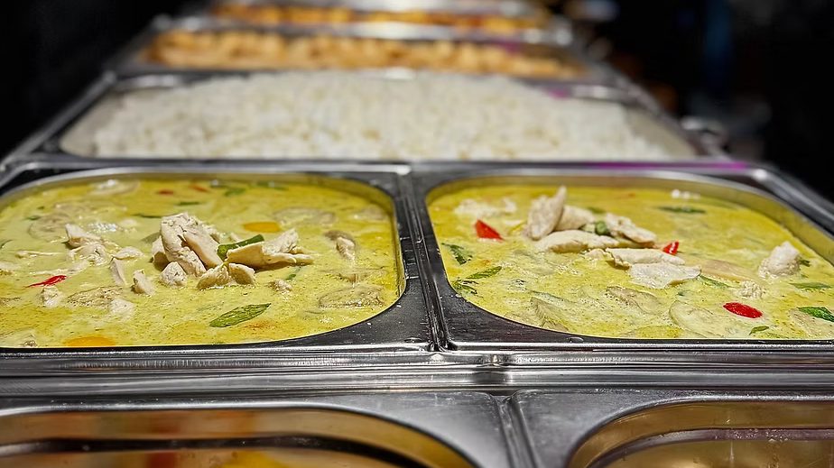 Thai green curry and rice on a buffet counter at Tom Yam Monton