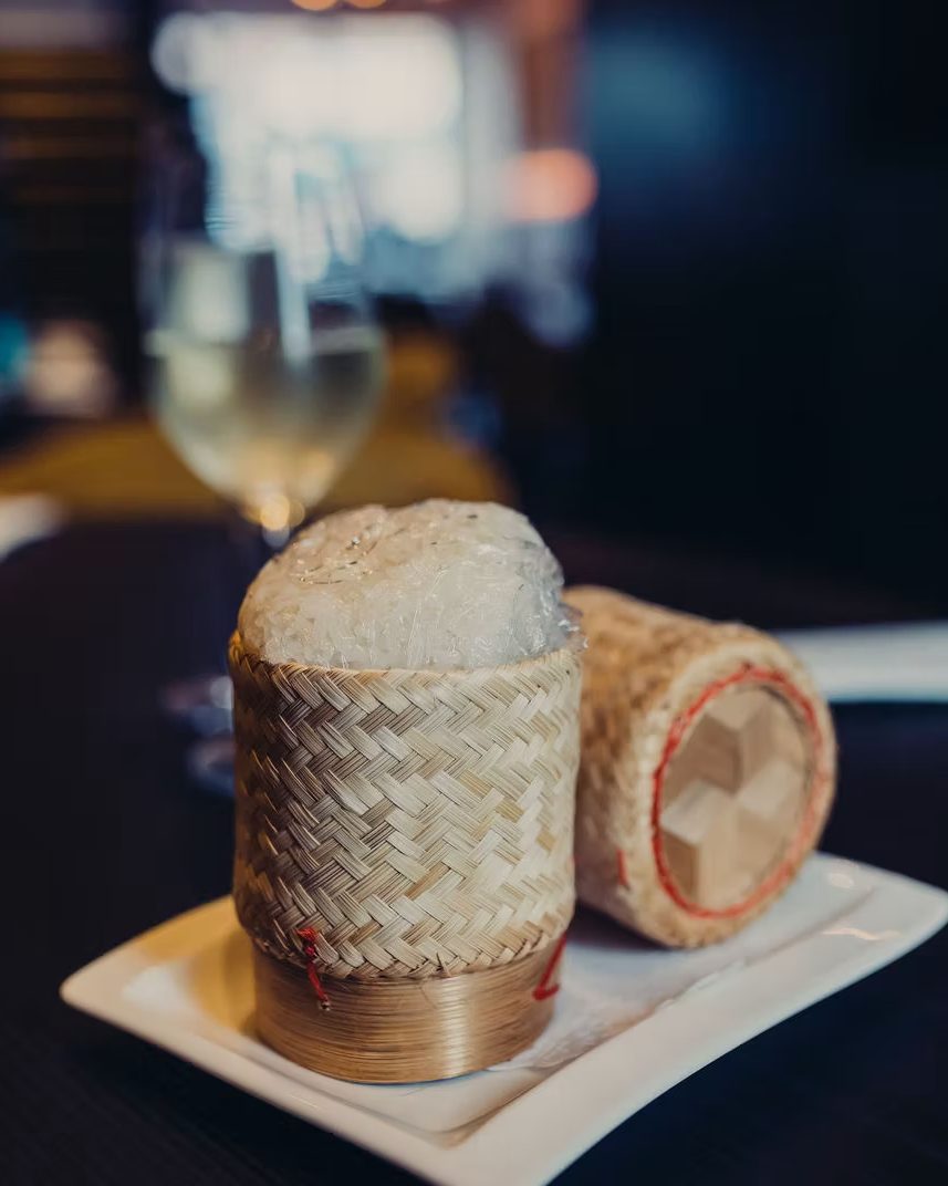 Sticky rice served in woven bamboo baskets